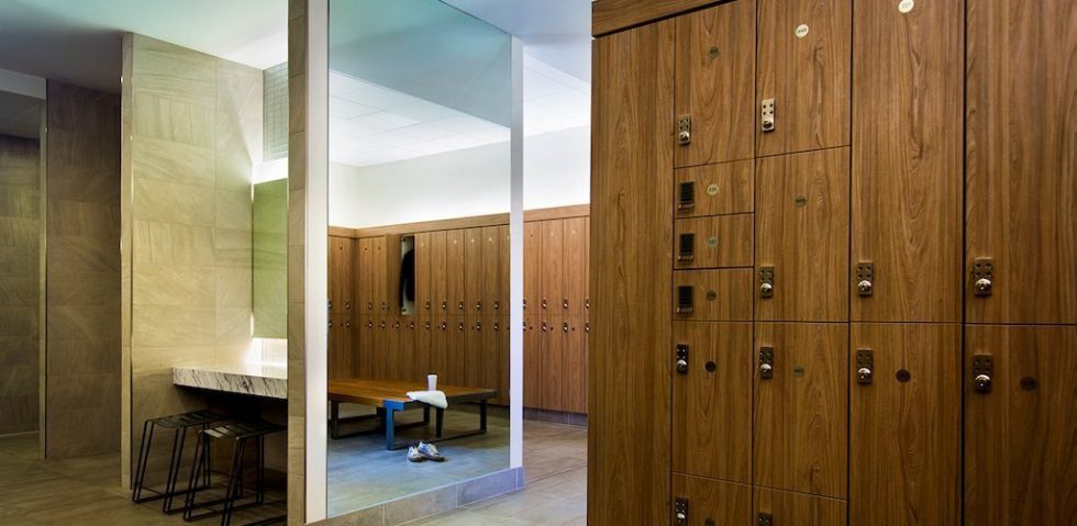 Full length mirror by rows of laminate lockers at Equinox.