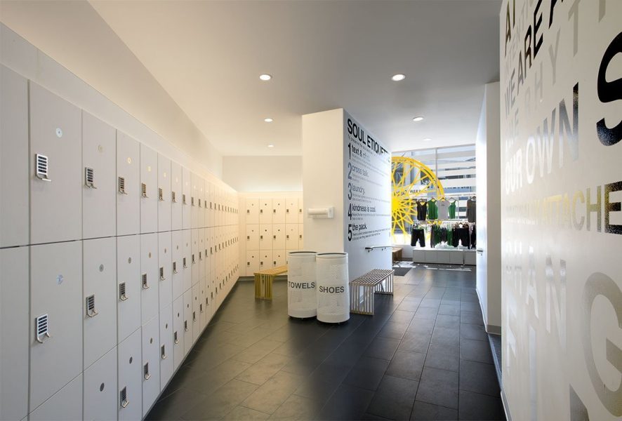 White laminate lockers at Soul Cycle, bold black letters on white walls.